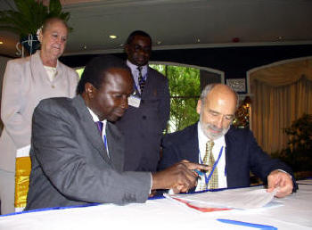 Hon. Daudi Migereko, Minister of Trade, Tourism and Wildlife, Republic of Uganda and Louis DAmore, IIPT Founder and President sign agreement to on 4th IIPT African Conference to be held in Uganda in partnership with the Africa Travel Association.